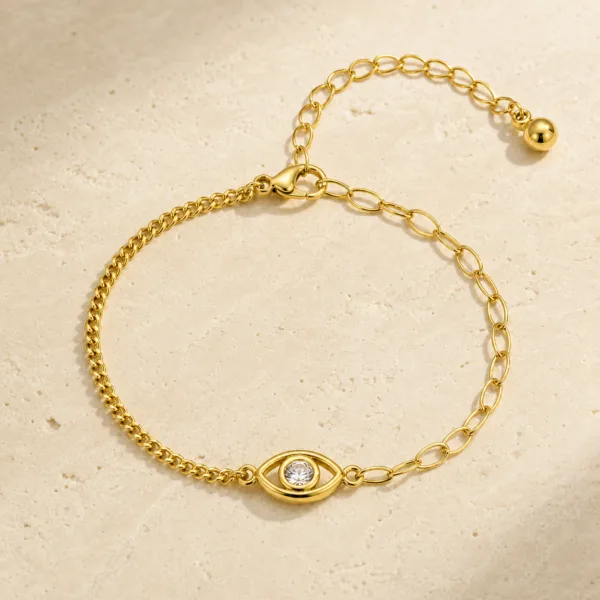 pulseira dourada olho protetor com cristal em pedra clara de tom quente, referência 85383-1
