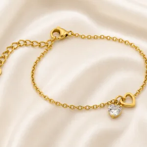 pulseira dourada com coração de cristal em cetim marfim, referência 85383-3