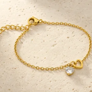 pulseira dourada com coração de cristal em pedra clara de tom quente, referência 85383-3