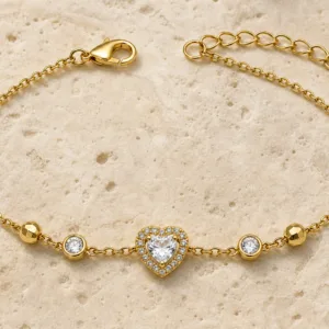 pulseira dourada com coração de cristal e halo em pedra clara de tom quente, referência 85384-5