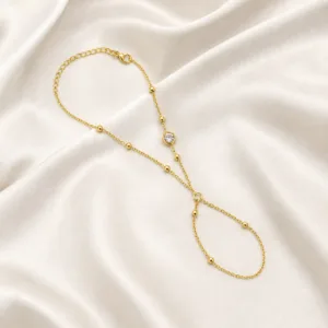 pulseira de mão dourada com cristal e anel em cetim marfim, referência 85384-6