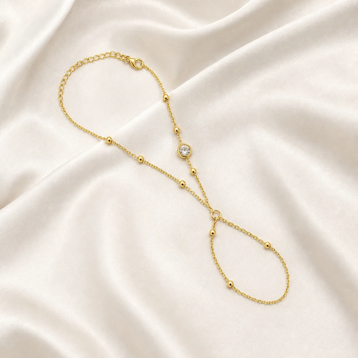 pulseira de mão dourada com cristal e anel em cetim marfim, referência 85384-6