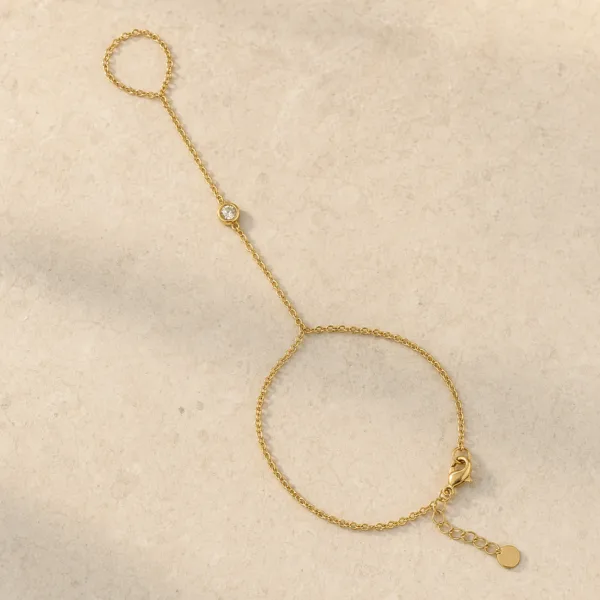 pulseira de mão dourada minimalista com cristal em pedra clara de tom quente, referência 85473-1