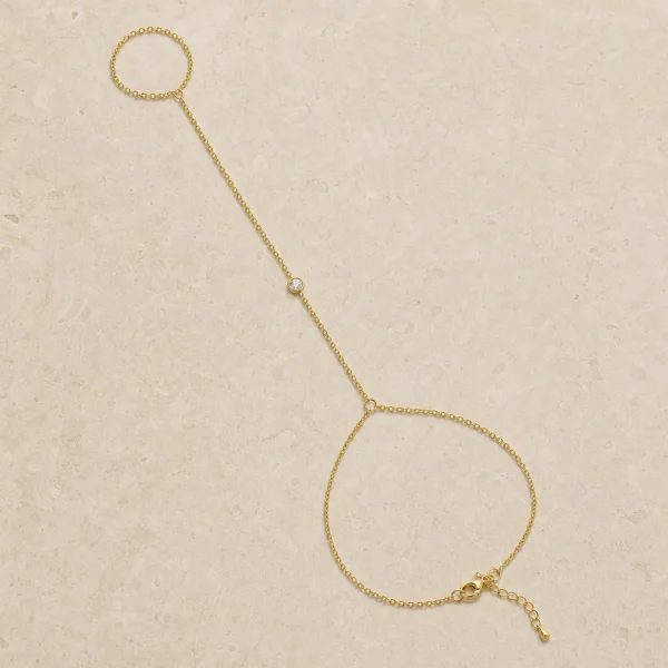 pulseira de mão dourada com cristal único em pedra clara de tom quente, referência 85474-4