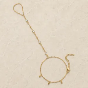 pulseira de mão dourada com quatro cristais e contas em pedra clara de tom quente, referência 85475-1