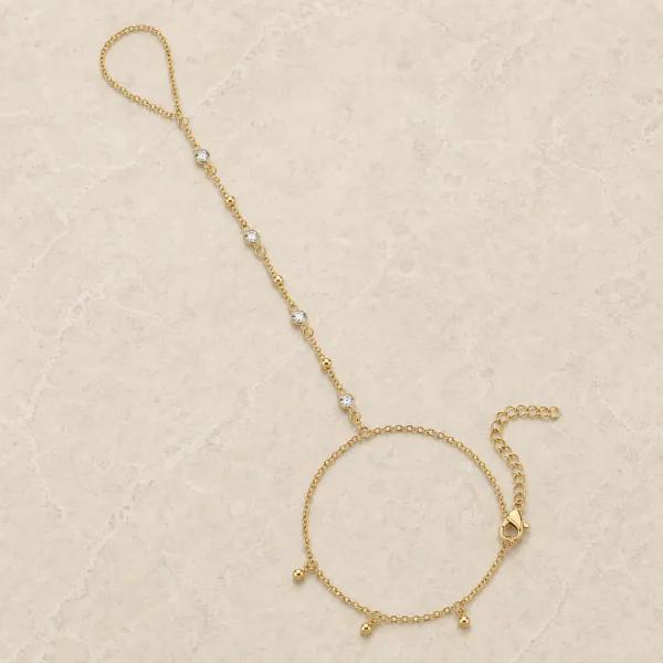 pulseira de mão dourada com quatro cristais e contas em pedra clara de tom quente, referência 85475-1